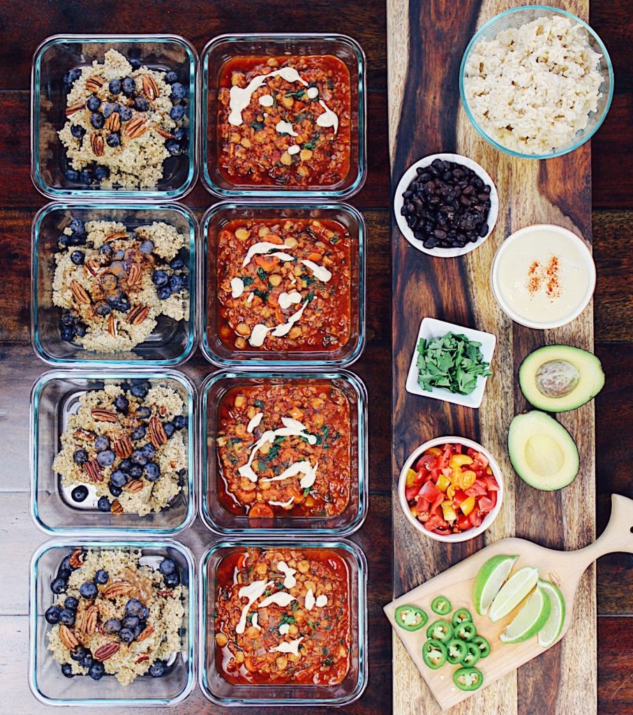 Meal Prep Photo with DIY Burrito Bowl Board, quinoa porridge, red curry chickpeas and lentils on table